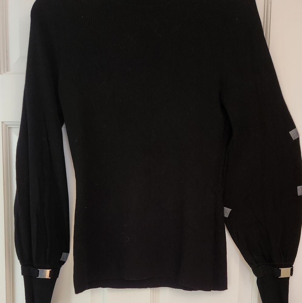 Turtleneck black sweader with metallic details on the sleeves. Size S/M
